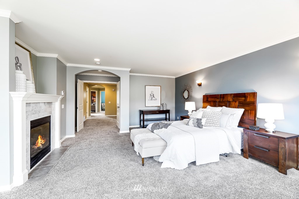 21303 37th Avenue Southeast Bothell, WA 98021 - Photo 17 of 34 a bedroom with a bed and a fireplace