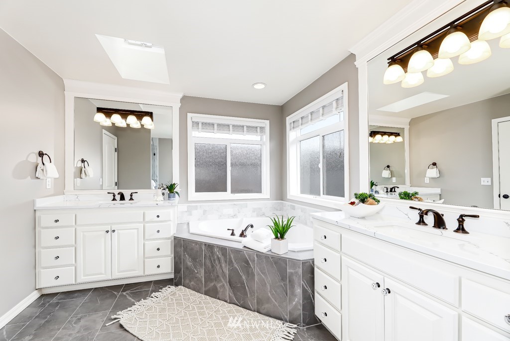 21303 37th Avenue Southeast Bothell, WA 98021 - Photo 18 of 34 a spacious bathroom with a granite countertop sink mirror and bathtub