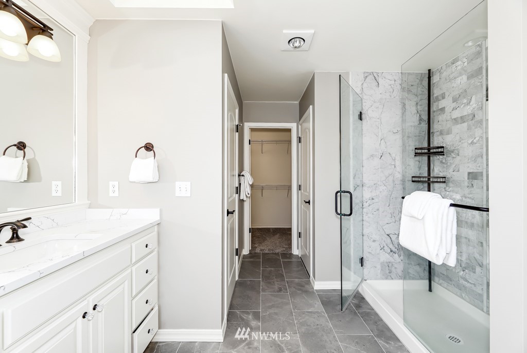 21303 37th Avenue Southeast Bothell, WA 98021 - Photo 19 of 34 a bathroom with a sink a toilet and shower