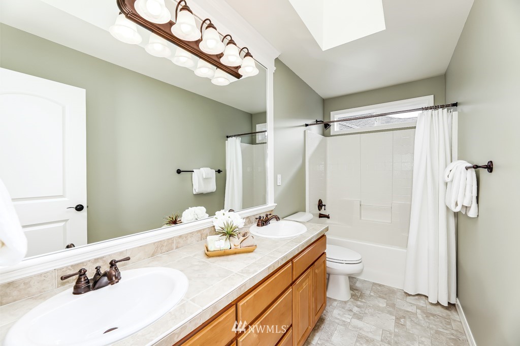 21303 37th Avenue Southeast Bothell, WA 98021 - Photo 24 of 34 a bathroom with a sink double vanity granite tub shower and a mirror