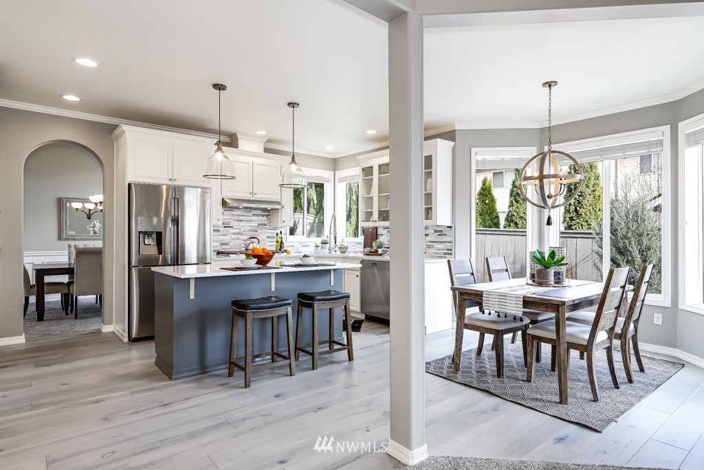 21303 37th Avenue Southeast Bothell, WA 98021 - Photo 4 of 34 a view of a dining room with furniture window and wooden floor