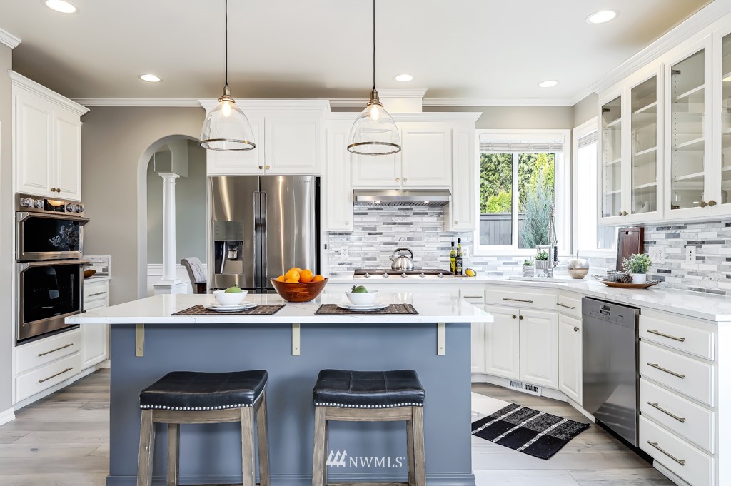 21303 37th Avenue Southeast Bothell, WA 98021 - Photo 5 of 34 a kitchen with stainless steel appliances granite countertop a sink and a stove