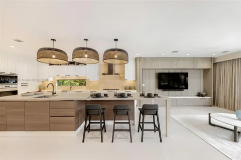 a large kitchen with stainless steel appliances granite countertop a lot of counter space and wooden floors