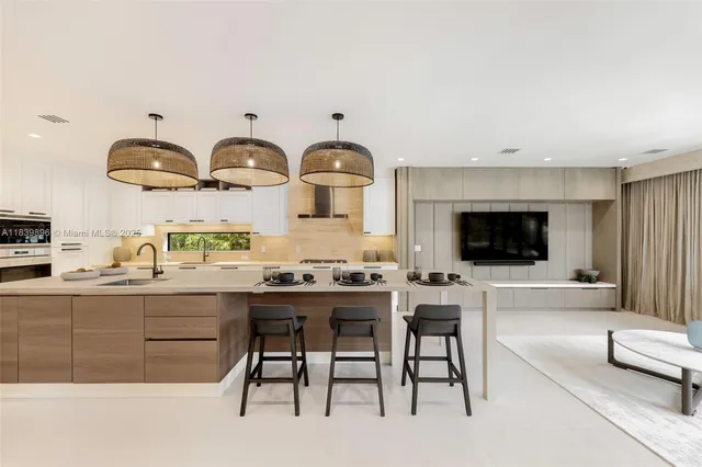 a large kitchen with stainless steel appliances granite countertop a lot of counter space and wooden floors