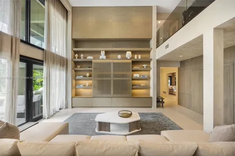 a bedroom with furniture and a large window