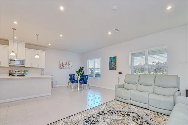 a kitchen with stainless steel appliances kitchen island granite countertop a refrigerator and a sink