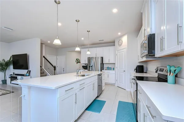 a dining room with furniture and a potted plant