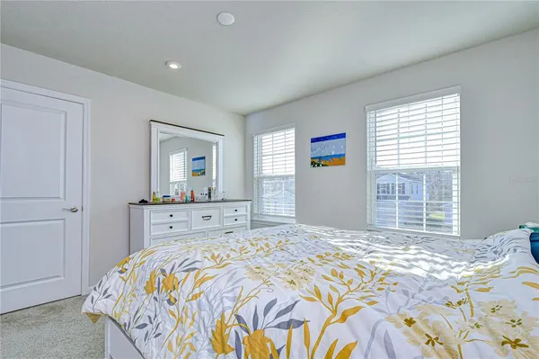 a bathroom with a double vanity sink mirror and next to a window