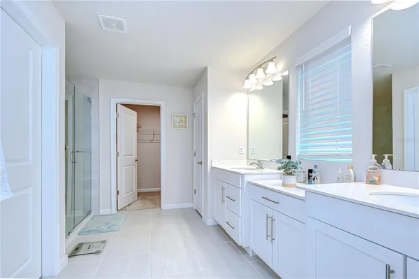a view of a dining room with furniture a chandelier and wooden floor