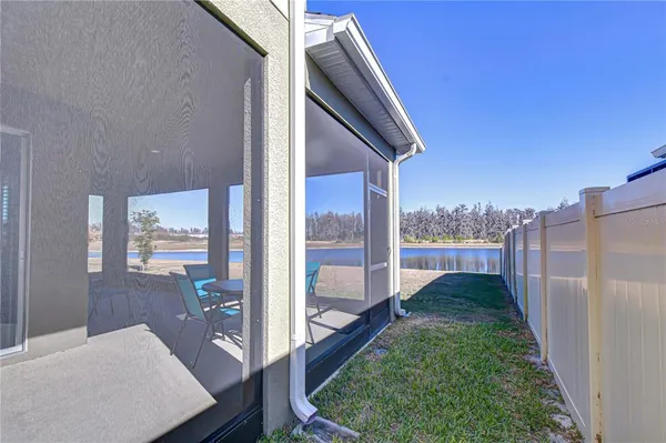 a front view of a house with swimming pool having outdoor seating