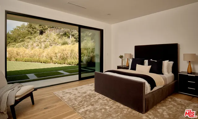 a bed room with a bed and a chair