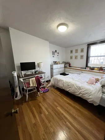 a bedroom with a bed and a window