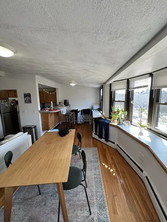 a large kitchen with a table and chairs
