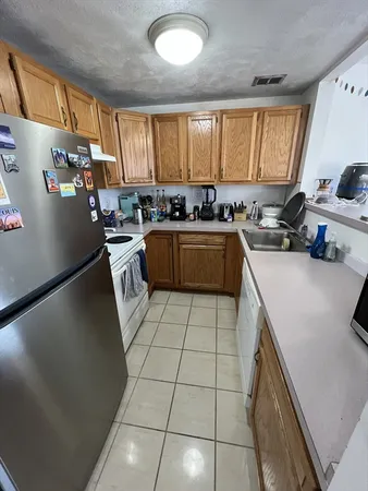 a kitchen with a sink a stove and refrigerator