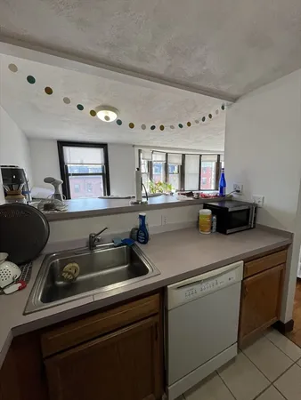 a kitchen with a sink cabinets and window
