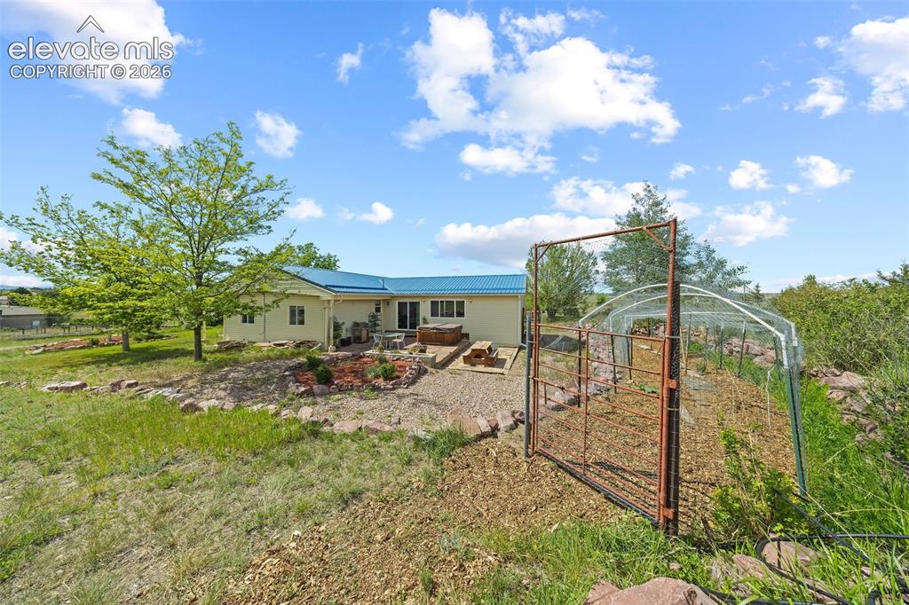 13075 Blaney Road South Peyton, CO 80831 - Photo 36 of 40 Rear exterior featuring sliding glass doors to backyard.