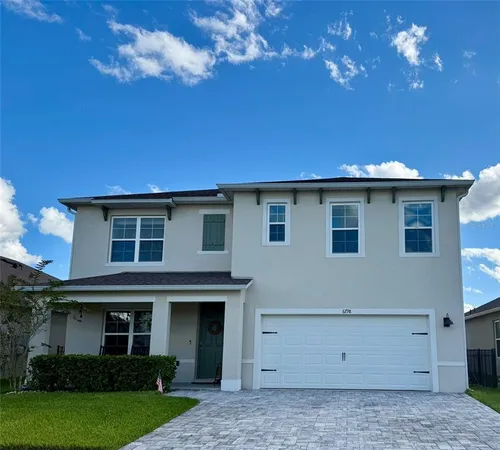 a view of a house with a backyard