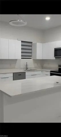 a kitchen with a refrigerator and a sink