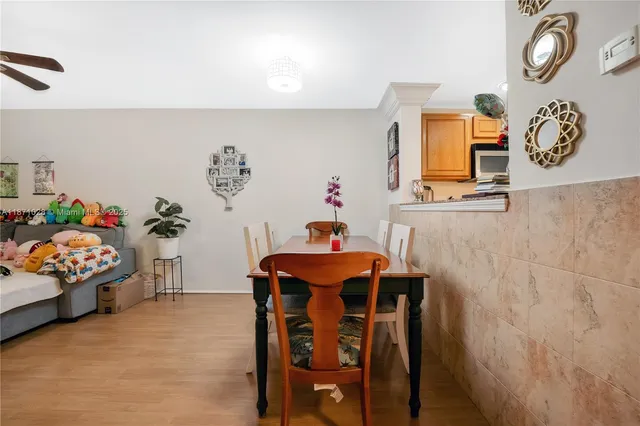 a dining room with furniture and wooden floor