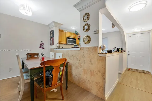 a view of a dining room with furniture and wooden floor