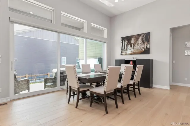 a open kitchen with stainless steel appliances kitchen island granite countertop a sink dishwasher a stove a refrigerator and cabinets with wooden floor