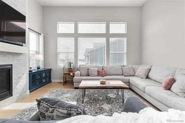 a living room with furniture kitchen view and a chandelier