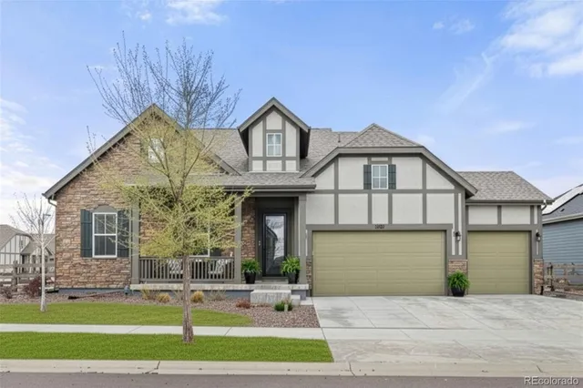 a front view of a house with a yard and garage