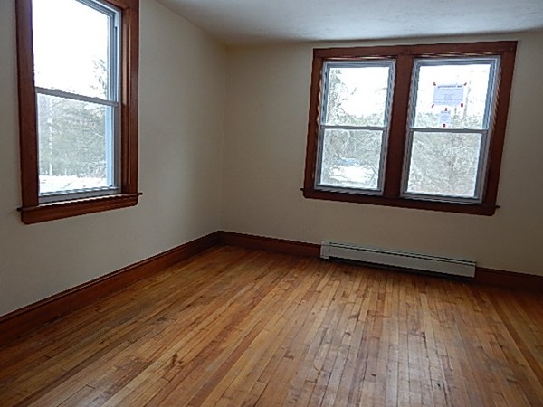 316 South Barre Road Barre, MA 01005 - Photo 8 of 16 an empty room with wooden floor and windows