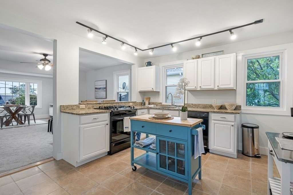 18 King Street, Unit 1 Swampscott, MA 01907 - Photo 12 of 27 a kitchen with a sink stove and cabinets