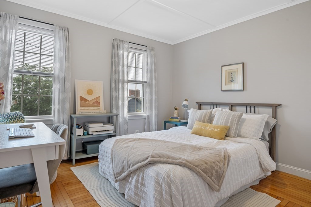 18 King Street, Unit 1 Swampscott, MA 01907 - Photo 17 of 27 a bedroom with a bed and wooden floor