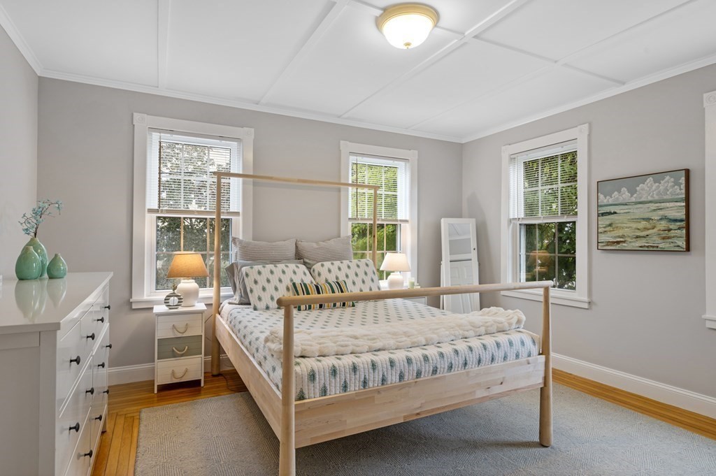 18 King Street, Unit 1 Swampscott, MA 01907 - Photo 19 of 27 a bedroom with a bed a window and potted plant