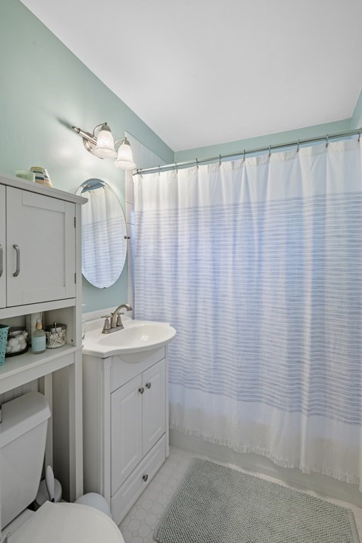 18 King Street, Unit 1 Swampscott, MA 01907 - Photo 21 of 27 a bathroom with a double vanity sink toilet and a mirror