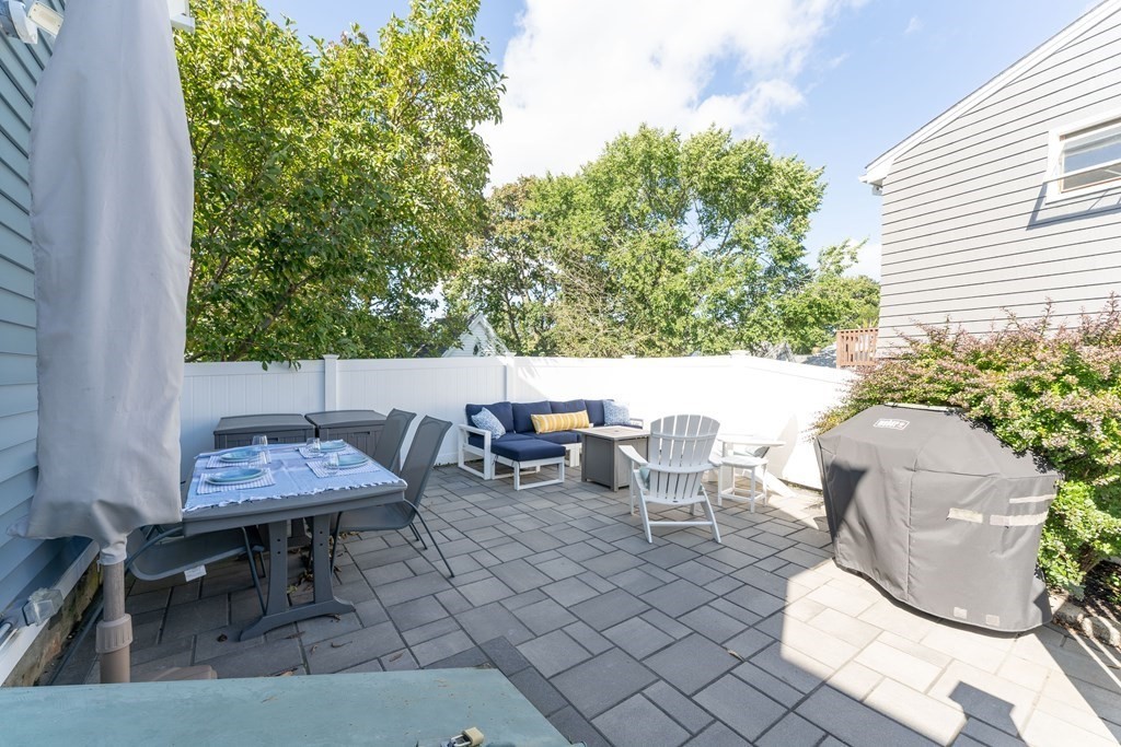 18 King Street, Unit 1 Swampscott, MA 01907 - Photo 26 of 27 a backyard of a house with table and chairs