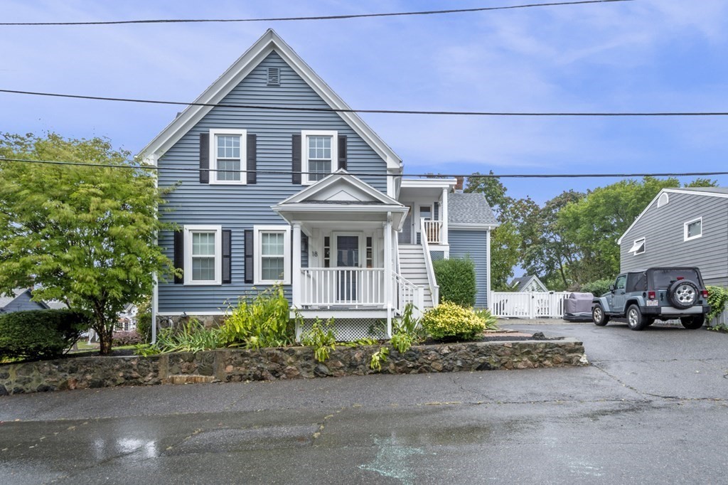 18 King Street, Unit 1 Swampscott, MA 01907 - Photo 4 of 27 front view of a house with a yard and a car parked in front of it
