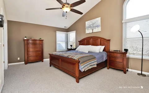 a bedroom with a bed and cabinets