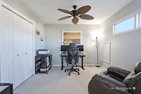 a view of a livingroom with workspace and a window