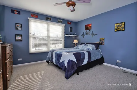 a spacious bedroom with a bed and a window