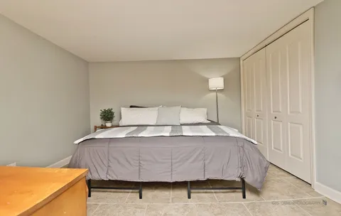 a bedroom with a bed and a night stand