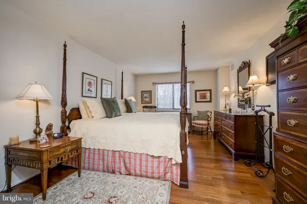 a bed room with furniture and a wooden floor
