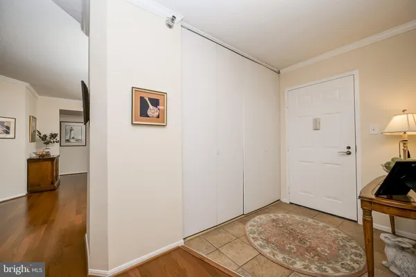 a view of a livingroom with wooden floor and a flat screen tv