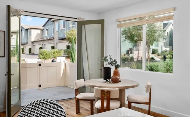 a view of a dining room with furniture window and wooden floor