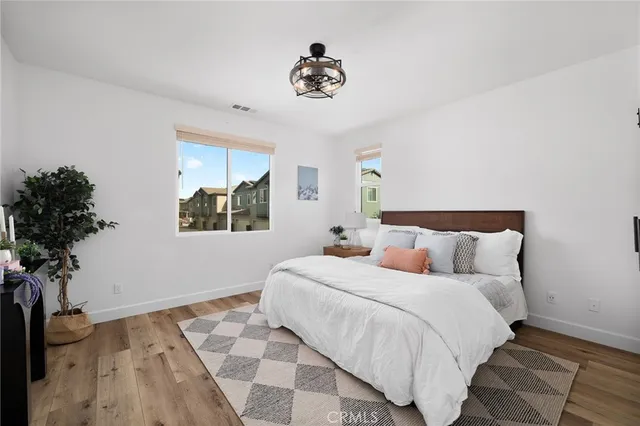 a bedroom with bed and a potted plant
