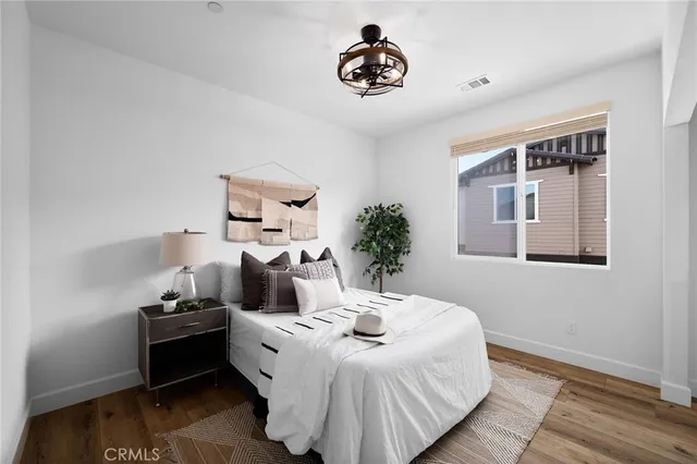 a bedroom with a bed and a potted plant