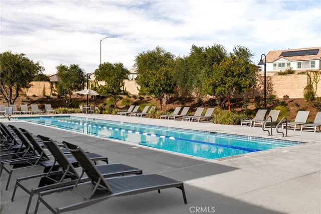 a view of a swimming pool with a table and chairs