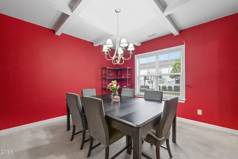 a dining room with furniture and chandelier