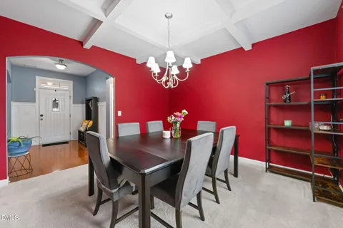 a view of a dining room with furniture and chandelier