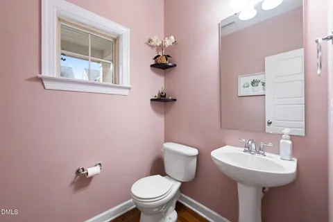 a bathroom with a sink toilet and a mirror