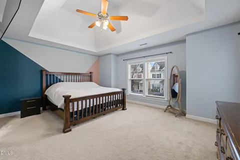 a bedroom with a bed next to a window