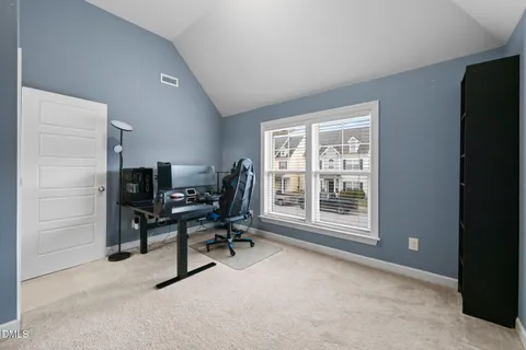 a view of a workspace with furniture and a window