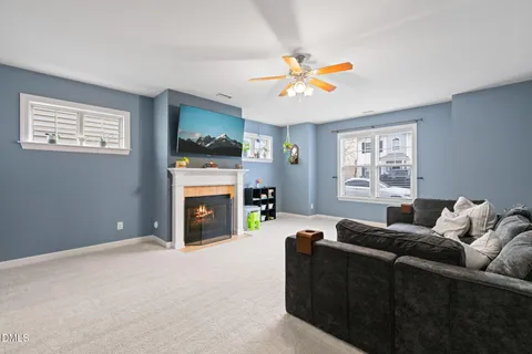 a living room with furniture a flat screen tv and a fireplace